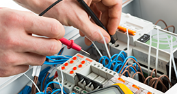 Technician measure electrical conductors for equipment calibration